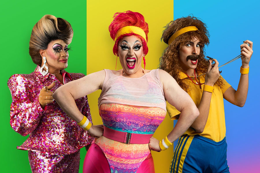 Photo of two drag queens and a drag king, on bright coloured backgrounds