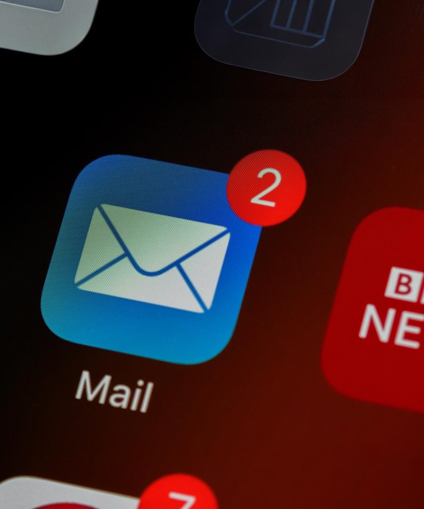 Screenshot of an iPhone home screen, showing the Mail app icon with 2 unread emails