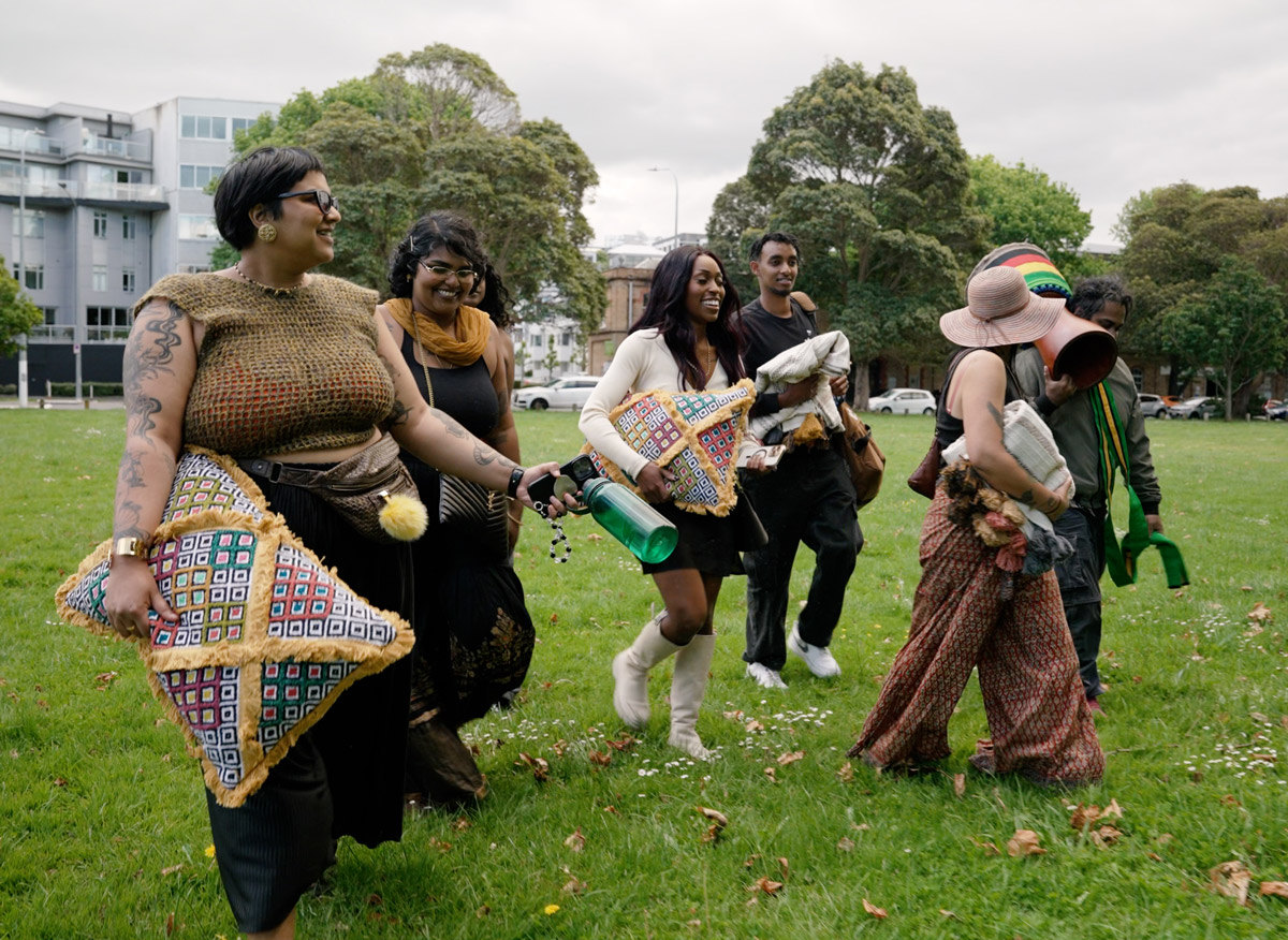 Photo of a group of people walking through an Auckland park